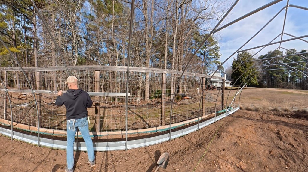 Installing the double channel that holds the high tunnel plastic