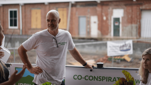 At the Canton Farmers Market in front of our sign "Co-Conspirators with Nature"